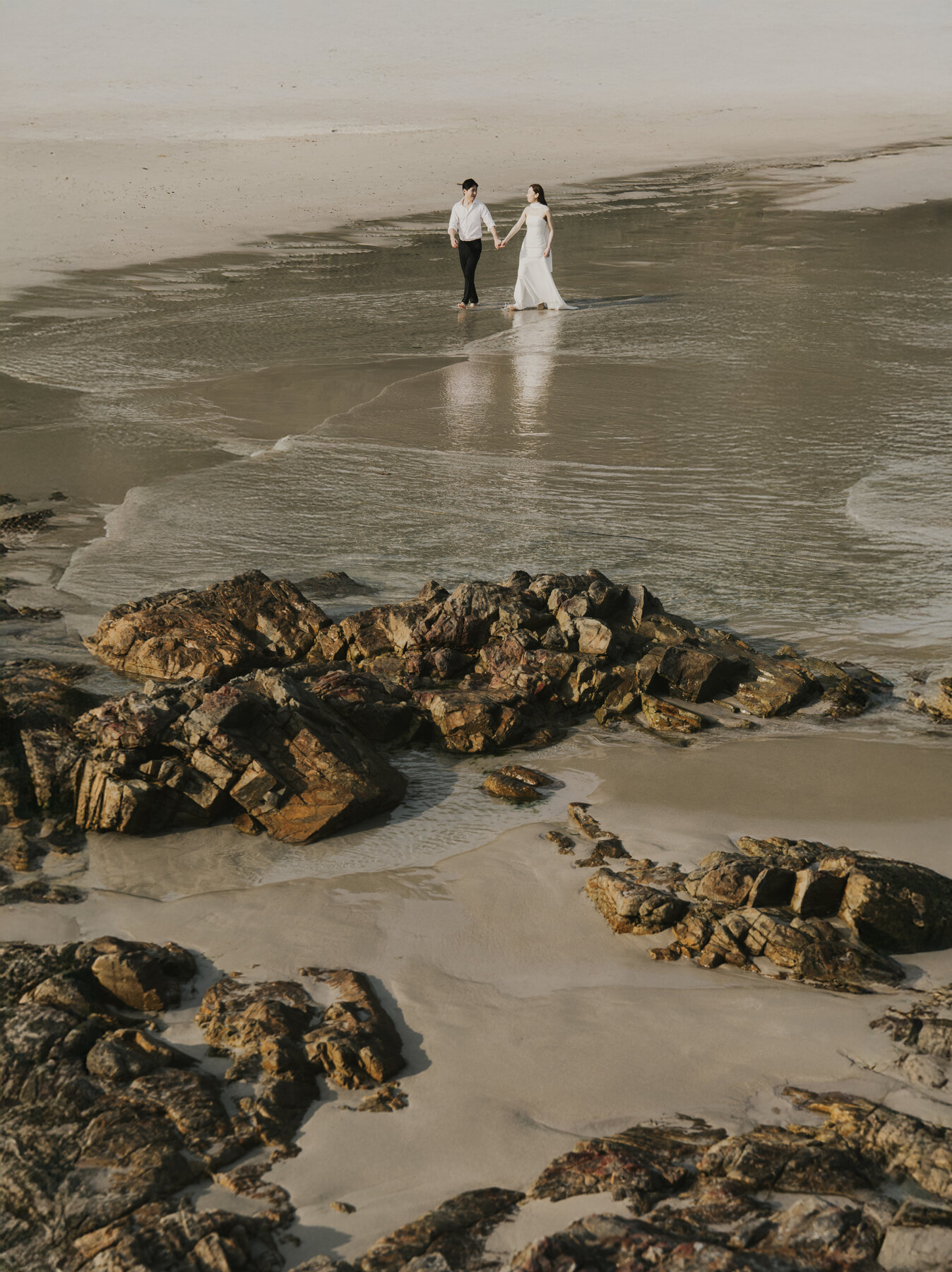 Couple embracing on the beach, black and white