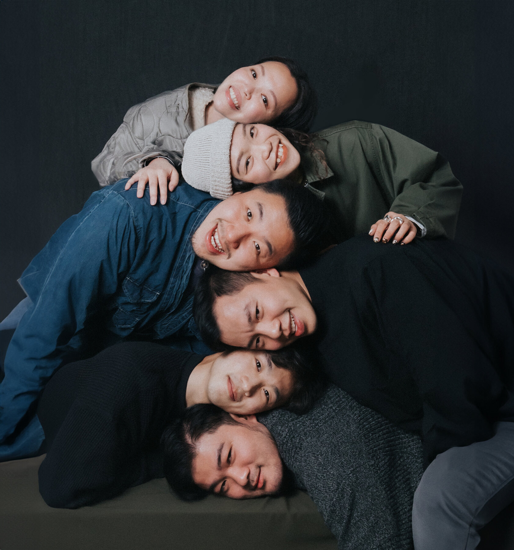 TIKIT team portrait, piled together laughing